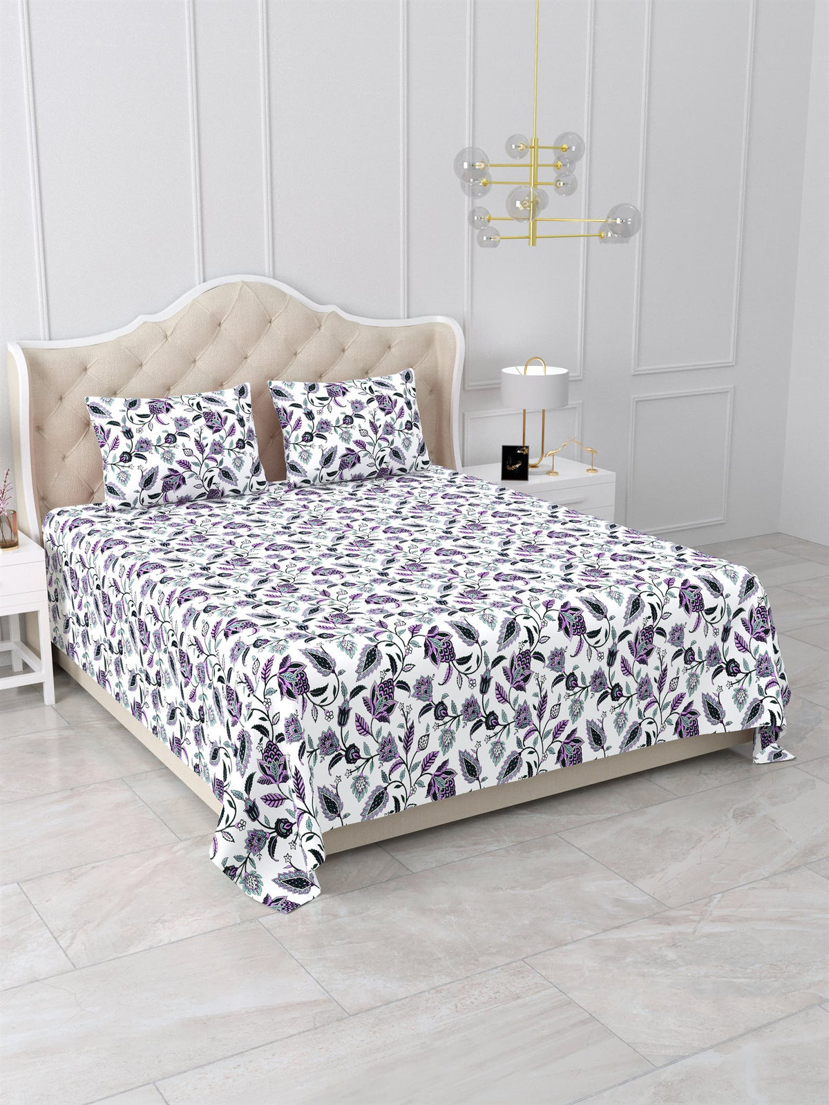 Angled view of the purple floral vine bedsheet on a bed