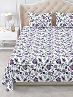 Close view of the purple and lavender floral vine bedsheet and pillow covers on the bed