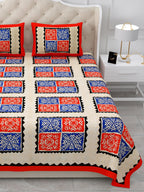Close view of red and royal blue square blocks with black zigzag frames on the bed