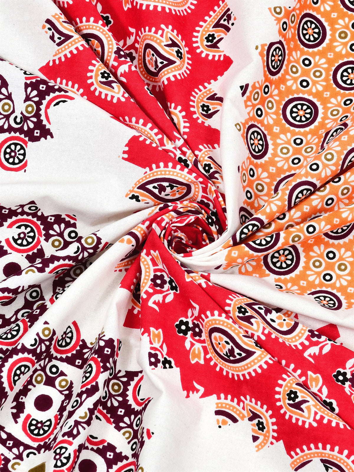 Swirled fabric close-up of red, peach and wine paisley print on white