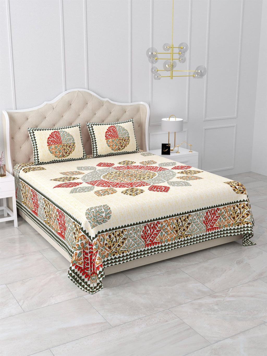 Angled view of the cream leaf mandala bedsheet showing the red and sage leaf-motif side border
