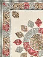 Flat corner close-up of the leaf mandala and red and sage leaf border on a cream base