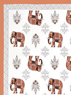 Close-up of decorated rust orange elephants and grey floral butas on a white base