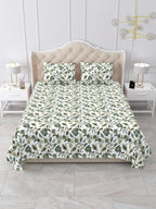 Front view of the sage green and white floral vine bedsheet on a bed with 2 matching pillow covers