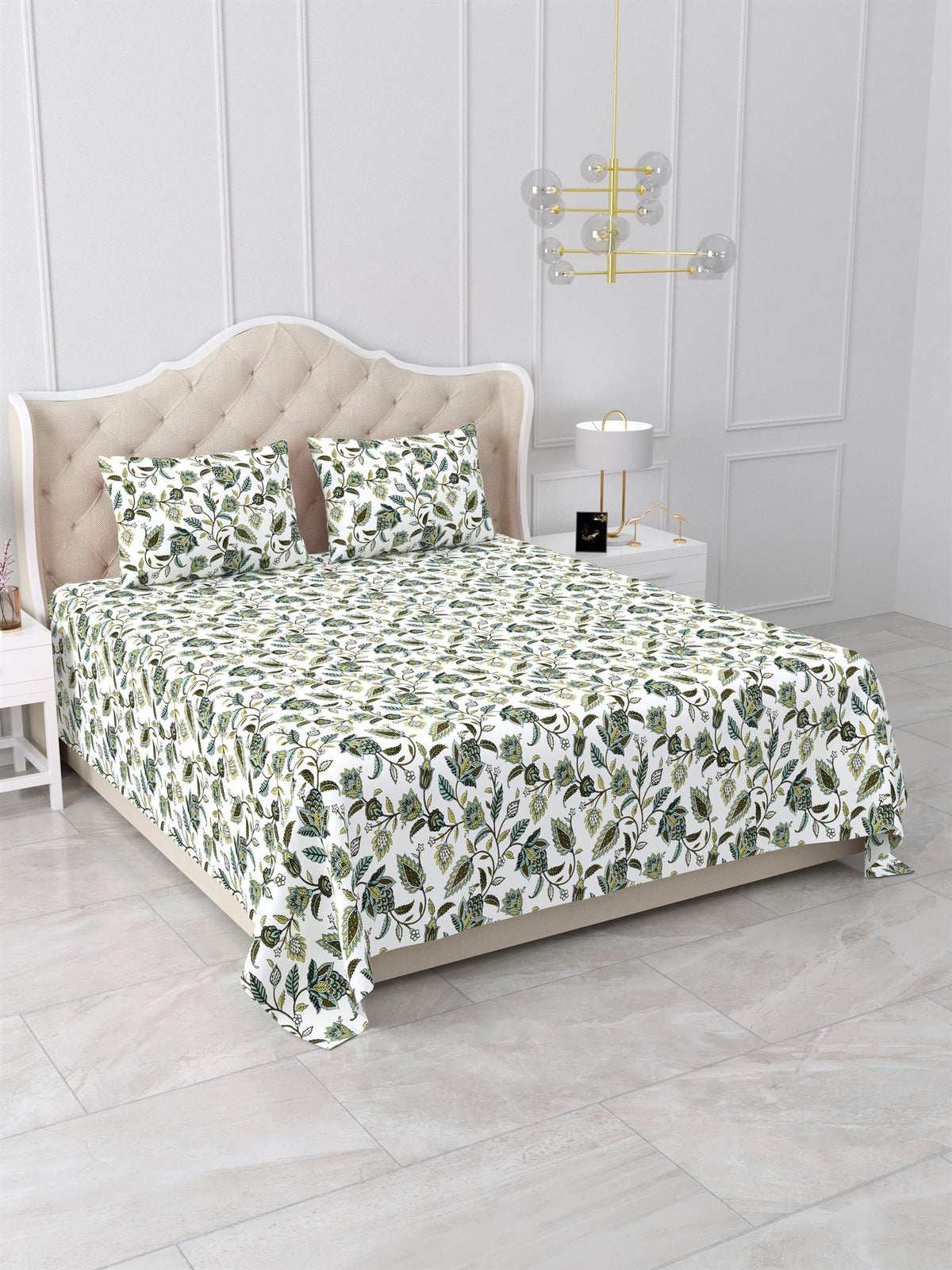 Angled view of the green floral vine bedsheet on a bed