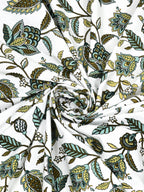 Swirled fabric close-up of olive, sage and mint floral vines on a white base