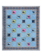 Full flat view of the sky blue peacock motif bedsheet with scattered patches and navy border