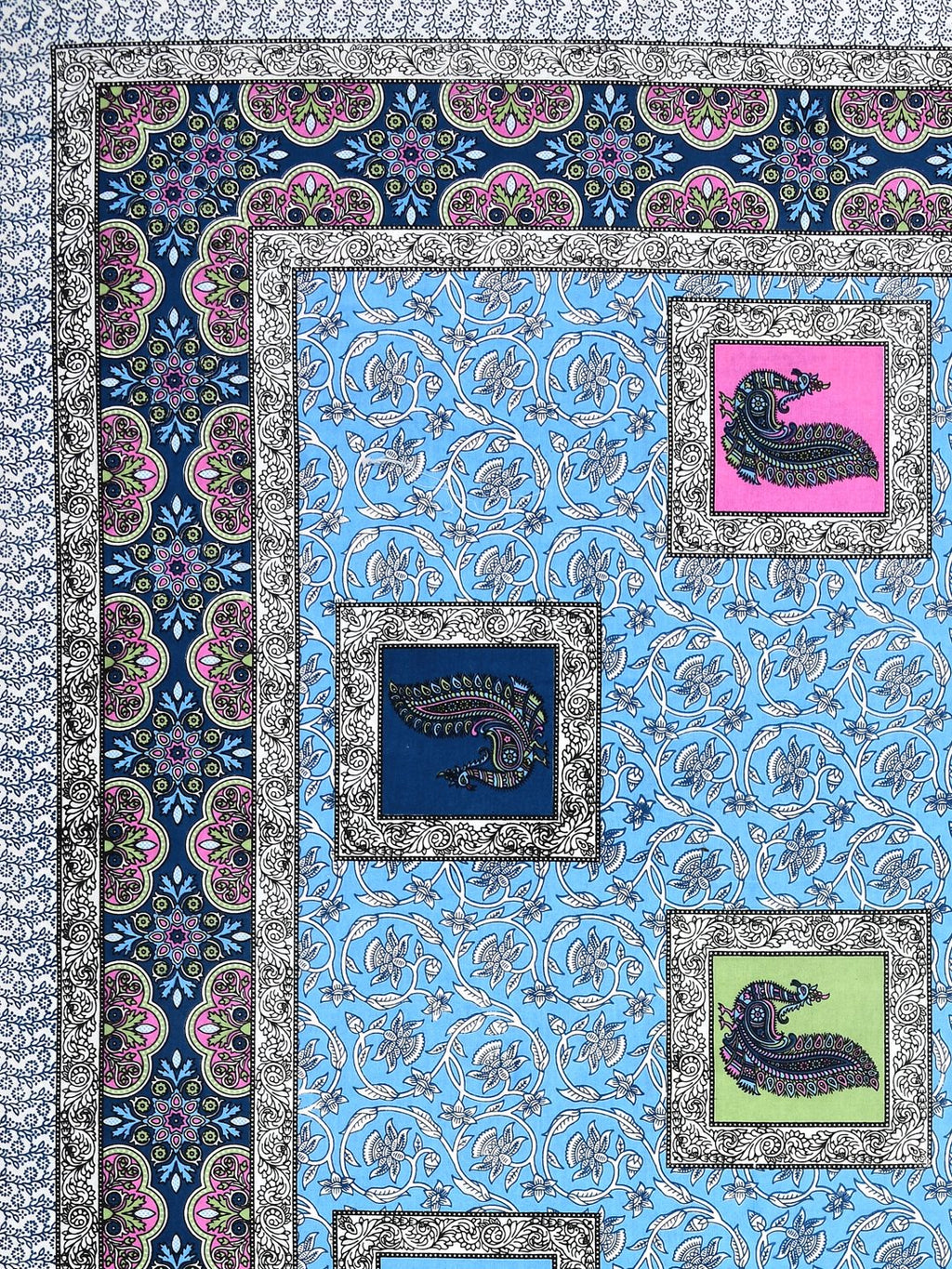 Close-up of pink, navy and lime peacock patches on a sky-blue floral vine background