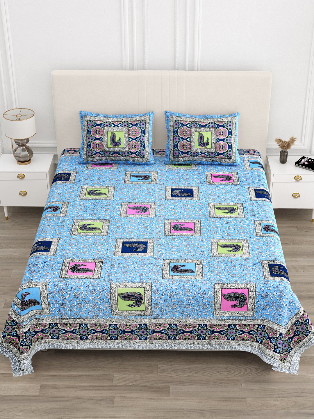 Front view of Castile India sky blue peacock motif bedsheet 90x108 on a bed with 2 pillow covers