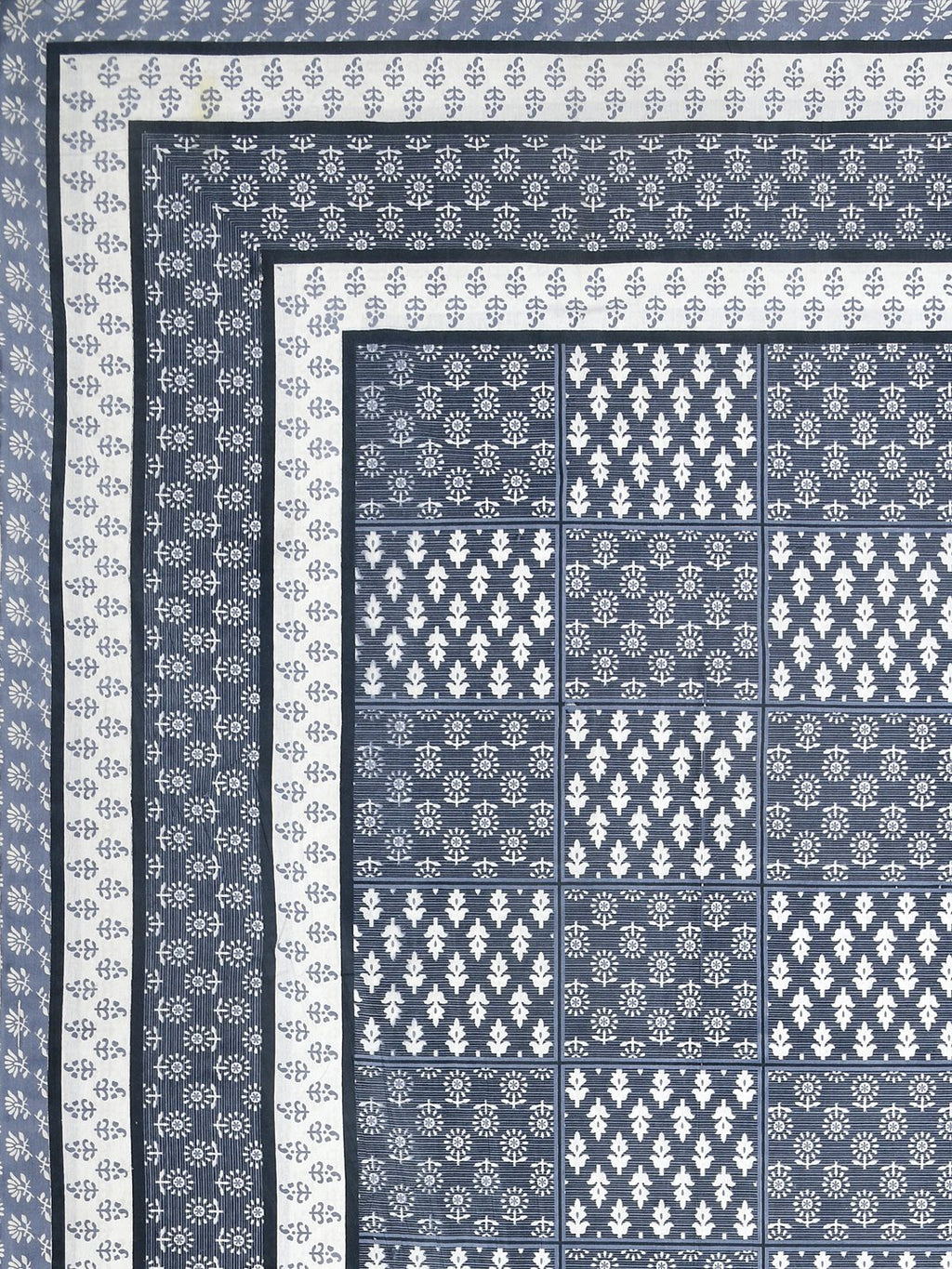 Flat corner view of the slate blue bedsheet showing the buta grid and layered stripe borders