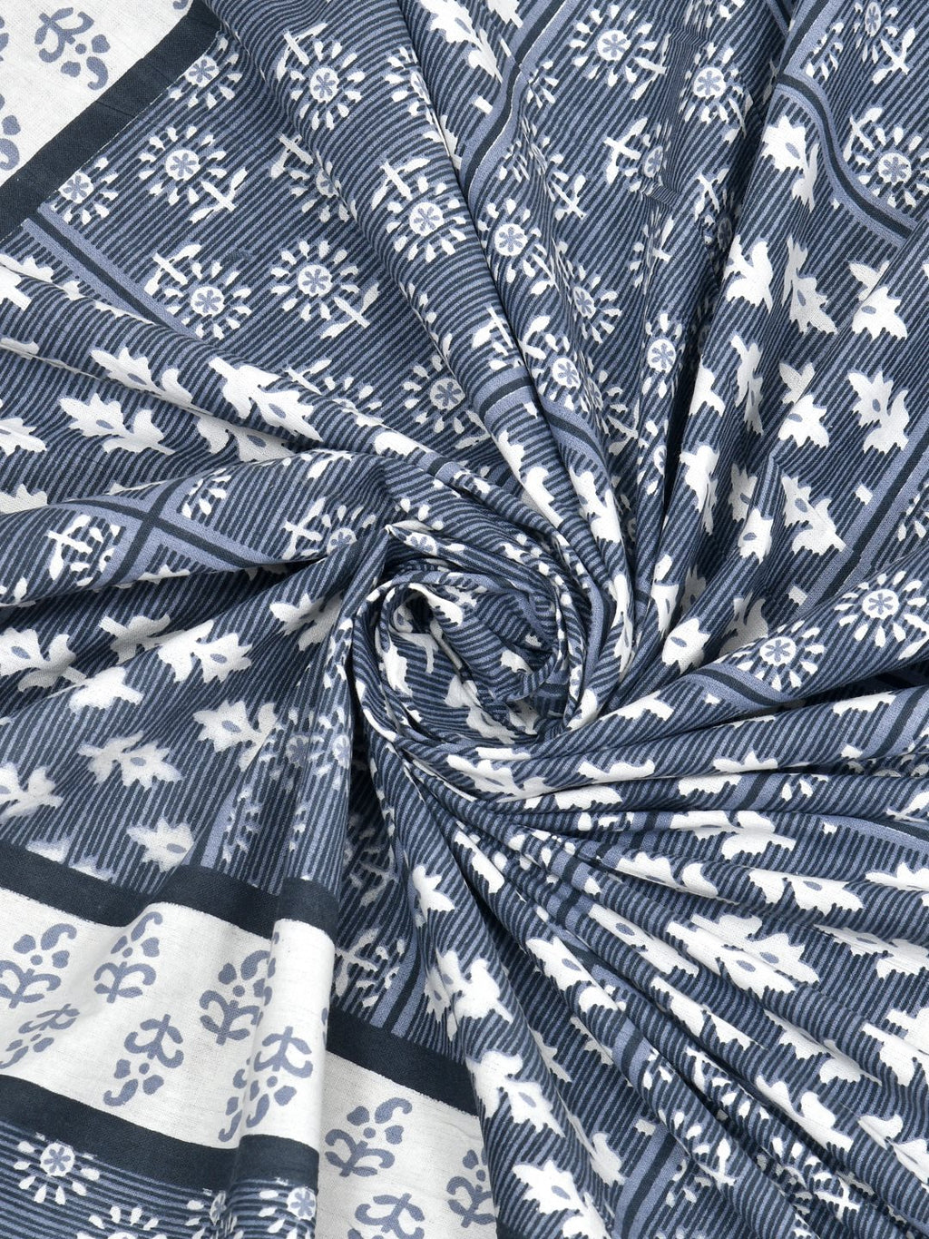 Swirled fabric close-up of white leaf and flower butas on a slate blue striped background