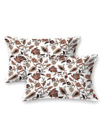 Two white pillow covers with rust, peach and brown trailing floral vine print