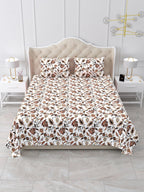 Front view of the white and rust floral vine bedsheet on a bed with 2 matching pillow covers