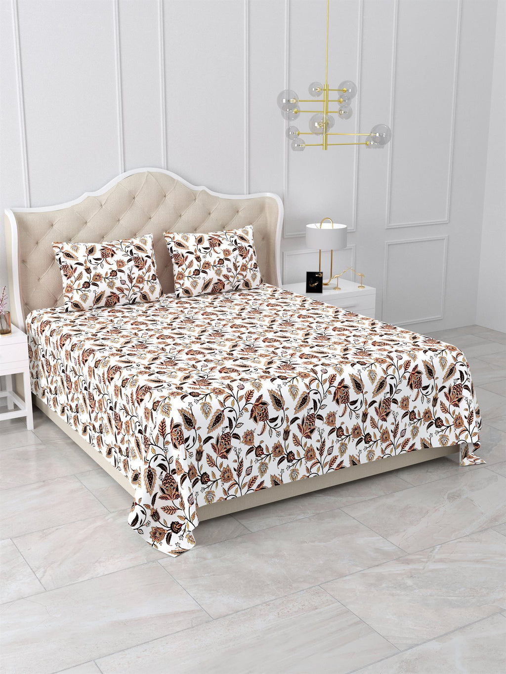 Angled view of the white floral vine bedsheet with rust and brown flowers on a bed