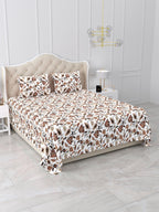 Angled view of the white floral vine bedsheet with rust and brown flowers on a bed