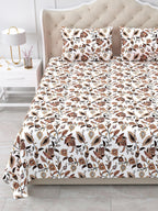 Close view of the rust and brown floral vine bedsheet and pillow covers on the bed